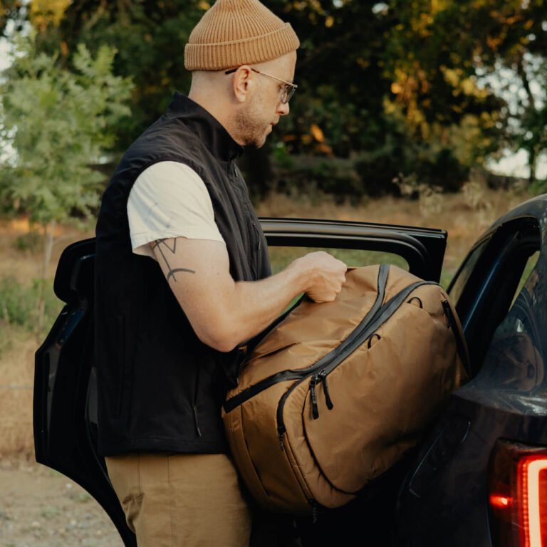 Peak Design Travel Backpack 45L loaded into the back of a car, shown in multi-carry mode