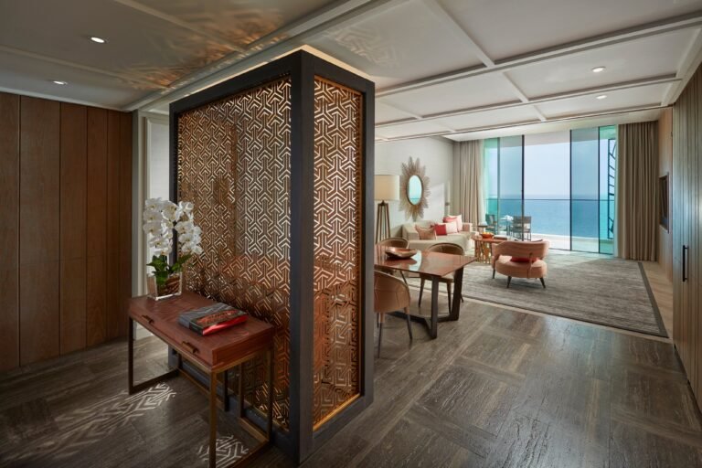 Living and dining area of the Two Bedroom Sea View Suite with sea view and Mandarin Oriental fretwork screen