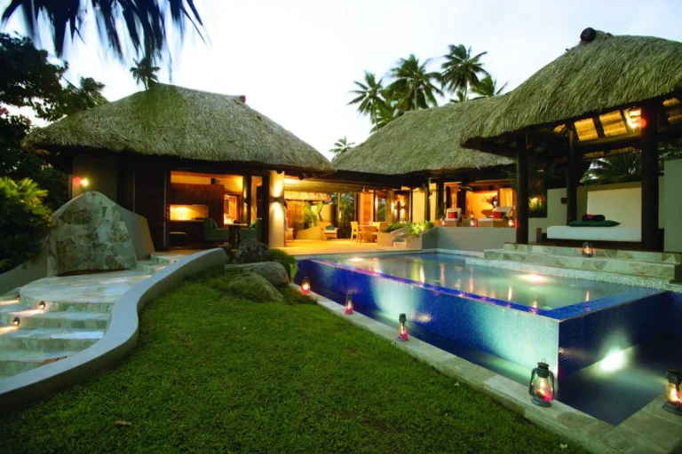 Private infinity pool at the Premium Oceanfront Two-Bedroom Villa, Jean-Michel Cousteau Resort Fiji, lit at dusk