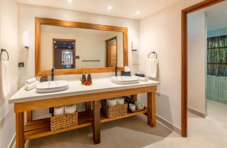 Bathroom of the Signature Oceanfront Two-Bedroom Bure at Jean-Michel Cousteau Resort Fiji, with a double vanity and natural timber finishes