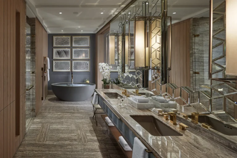 Marble bathroom with freestanding bathtub and dual vanity in a guest room at Mandarin Oriental Jumeira, Dubai