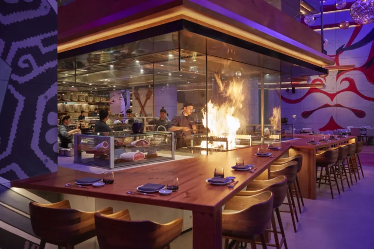 Chefs cooking over open flames at the Warayaki-style grill at Netsu, Mandarin Oriental Jumeira, Dubai