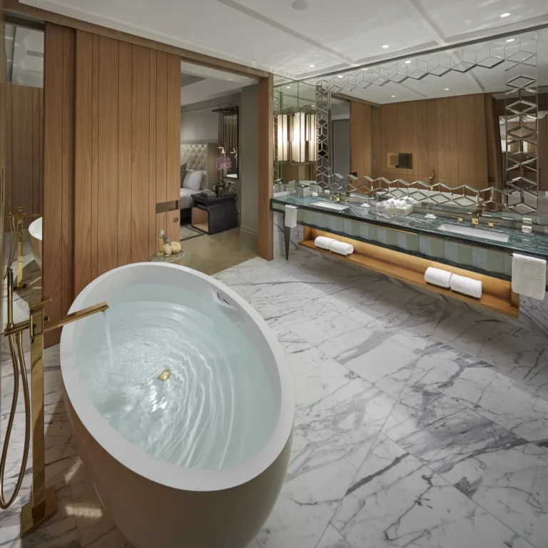 Freestanding oval bathtub on a marble bathroom floor in a suite at Mandarin Oriental Jumeira, Dubai