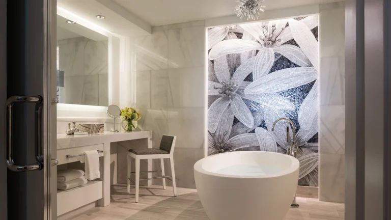 Guest bathroom at Four Seasons Resort Orlando with a freestanding soaking tub beside floral artwork