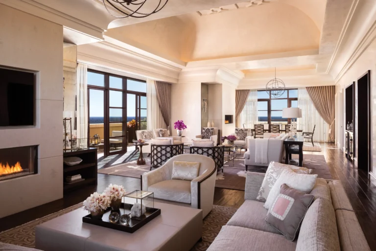 Grand Suite living room at Four Seasons Resort Orlando with a fireplace and floor-to-ceiling windows