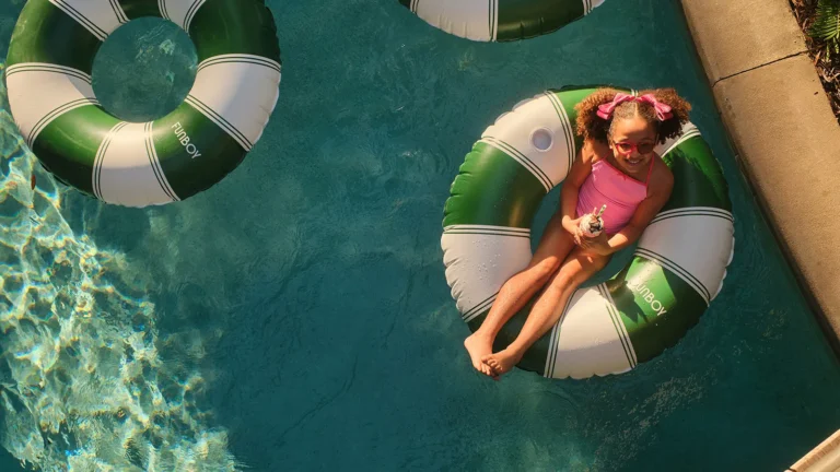 Aerial view of a child floating on an inflatable ring in the lazy river at Four Seasons Resort Orlando