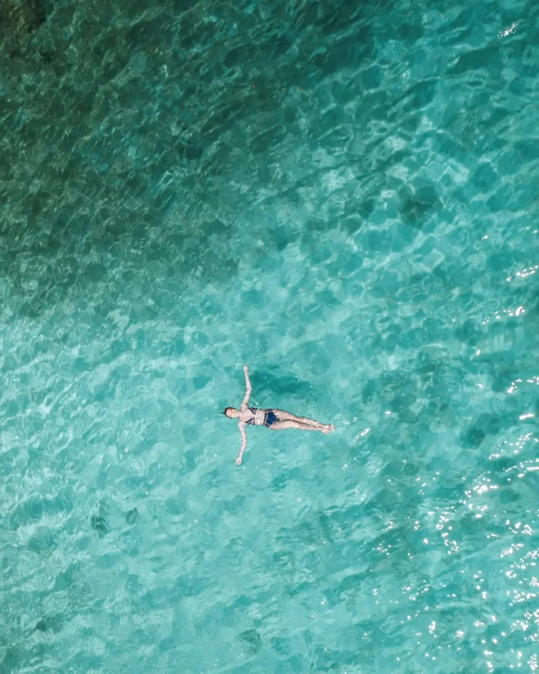 Young girl swimming in the clear Mediterranean sea