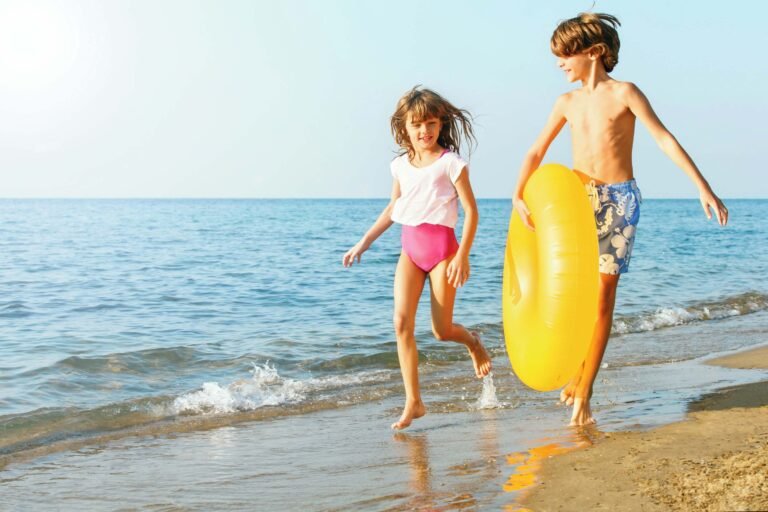 Children having fun by the sea at an Ikos resort beach