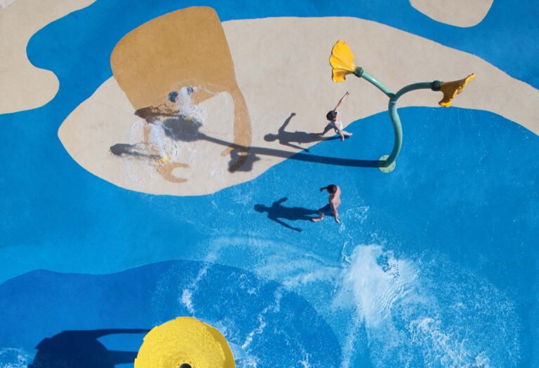 Children playing in a kids splash and water play area at an Ikos resort