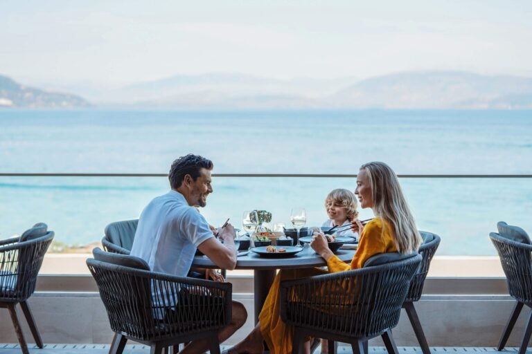 Family with children sharing lunch at the Anaya restaurant at an Ikos resort