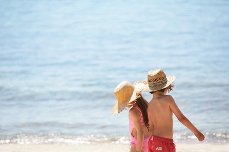 Children playing together on the sandy beach at an Ikos resort
