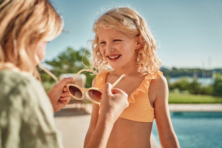 Mother and young daughter enjoying time together at the poolside at an Ikos resort