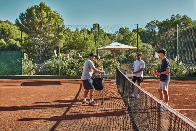 Tennis coaching at an Ikos resort court