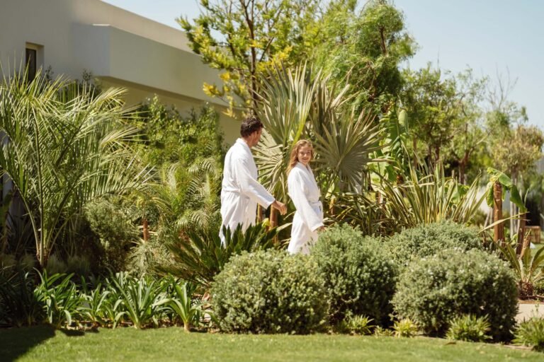 Couple walking through the resort grounds at Ikos Dassia