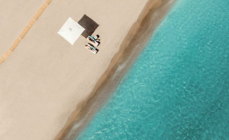 Couple relaxing on the beach at Ikos Dassia