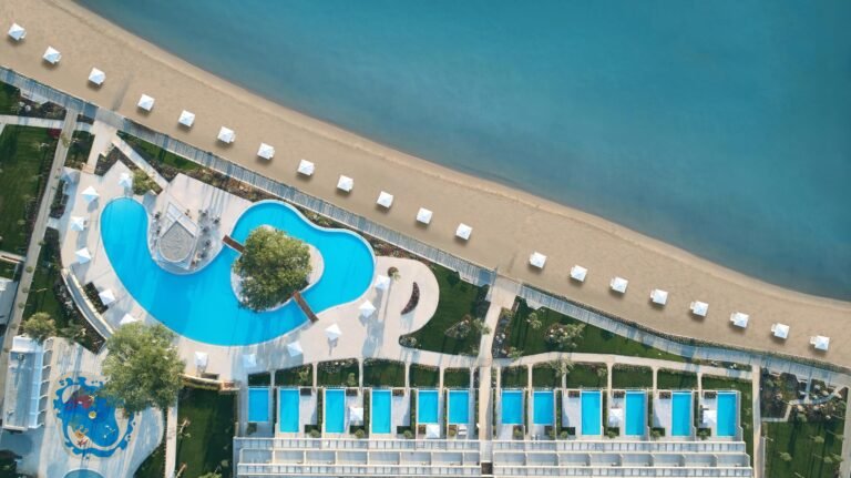 Aerial of Ikos Dassia buildings and coastline at Dassia, Corfu