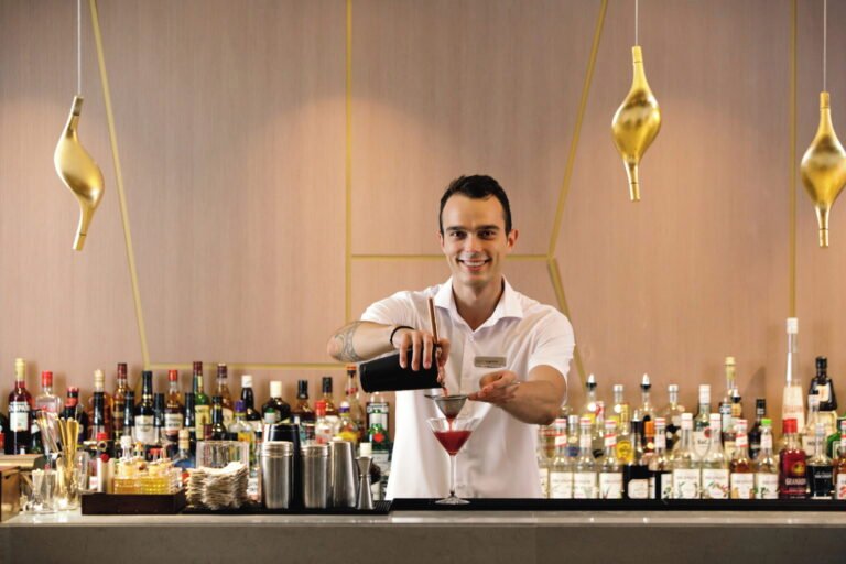 Bartender preparing cocktails at Ikos Dassia