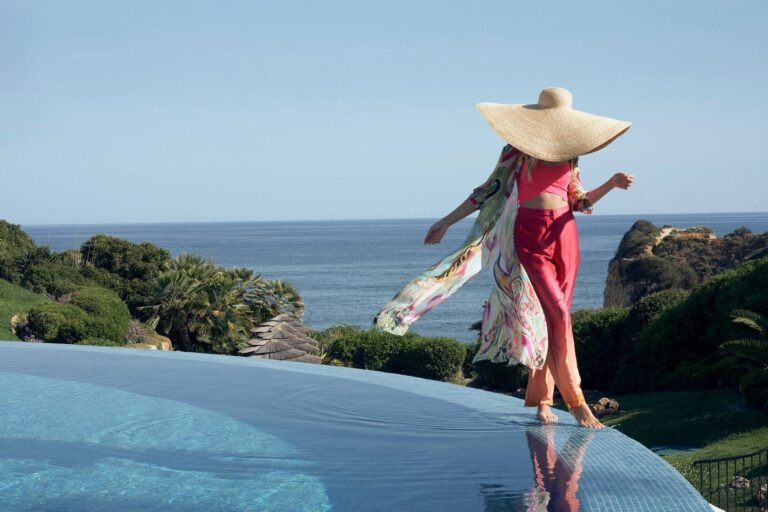 Infinity pool terrace at dusk with hanging chairs and Atlantic view, Vila Vita Parc