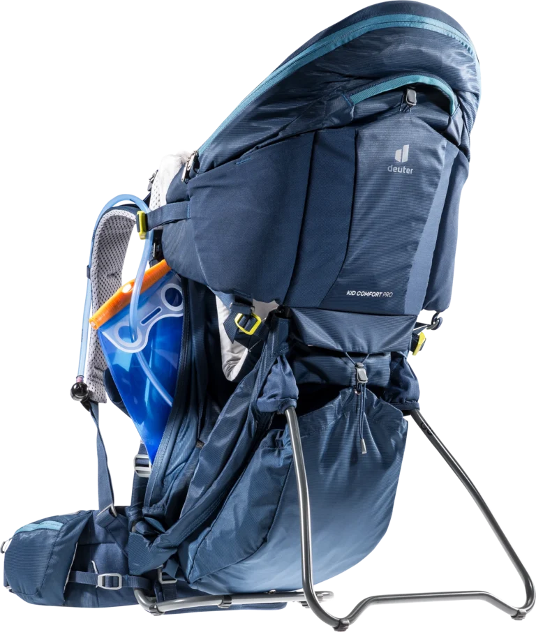 Side view of the Deuter Kid Comfort Pro with a hydration bladder fitted in the mesh back pocket, canopy deployed and kickstand out