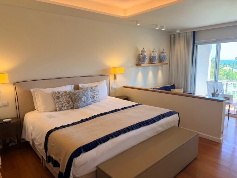 Suite bedroom at Vila Vita Parc with blue-and-white ceramics and a sea-view balcony