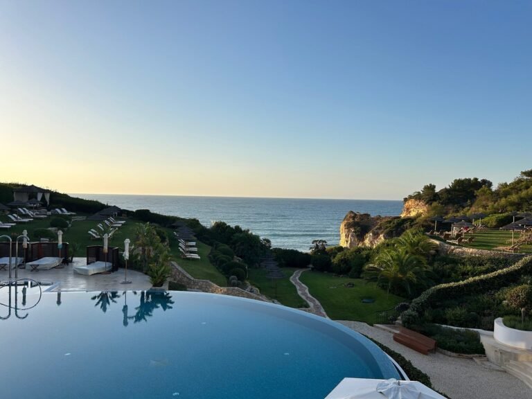 Clifftop infinity pool at golden hour overlooking the Atlantic, Vila Vita Parc