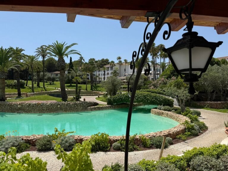 Garden pool with lantern and palms at Vila Vita Parc