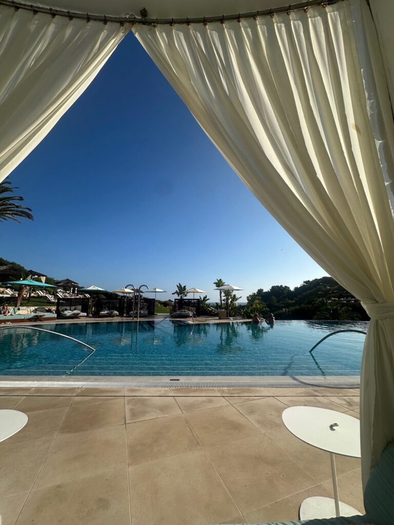 Cabana curtains framing the main pool and umbrellas at Vila Vita Parc