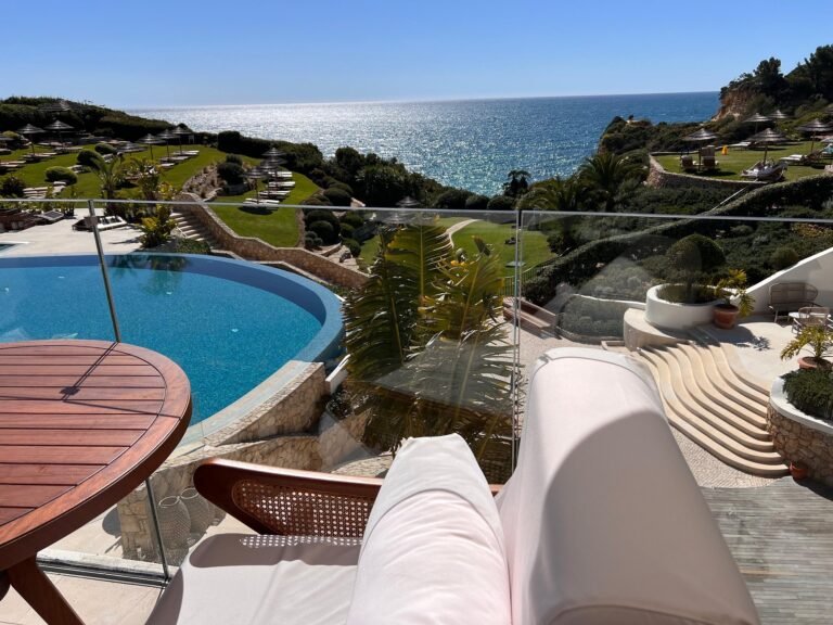 Vila Vita Parc white clubhouse building beside a freeform garden pool with fountains