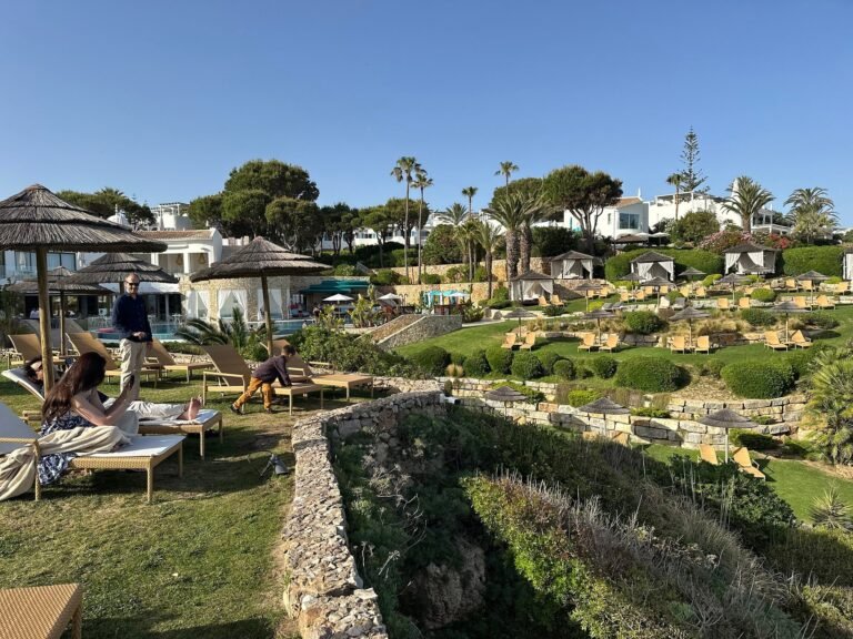 Pool terrace with sun loungers and guests relaxing at Vila Vita Parc