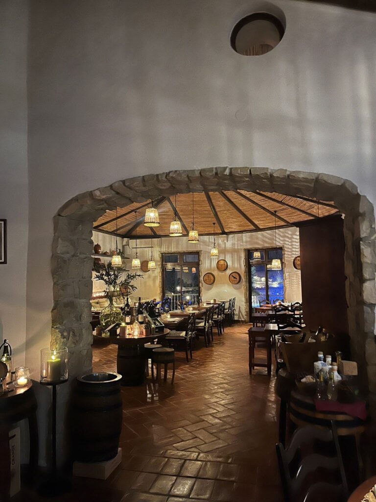Candlelit stone-arched wine restaurant at night, Vila Vita Parc