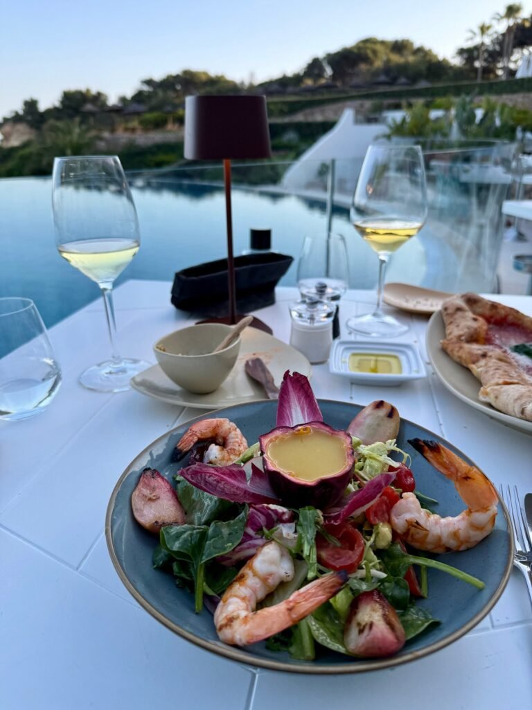 Poolside dinner of grilled prawn salad with sea view at Vila Vita Parc