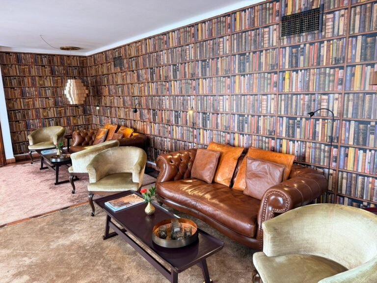 Botanical-print lobby lounge at Vila Vita Parc with fireplace and blue armchairs