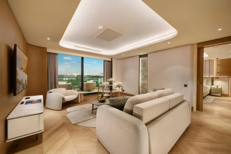 Suite living room with sea-view balcony at Regnum The Crown