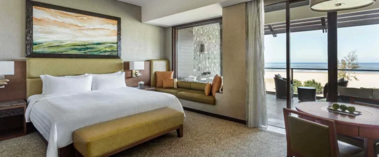 Luxury room interior at Shangri-La Rasa Ria with sea view balcony and king bed