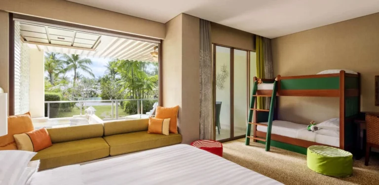 Ocean Wing Junior Suite configured for families at Shangri-La Rasa Ria with twin beds and sea view