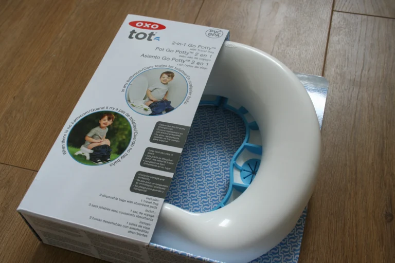 OXO Tot 2-in-1 Go Travel Potty unfolded in freestanding mode with its drawstring travel bag beside it