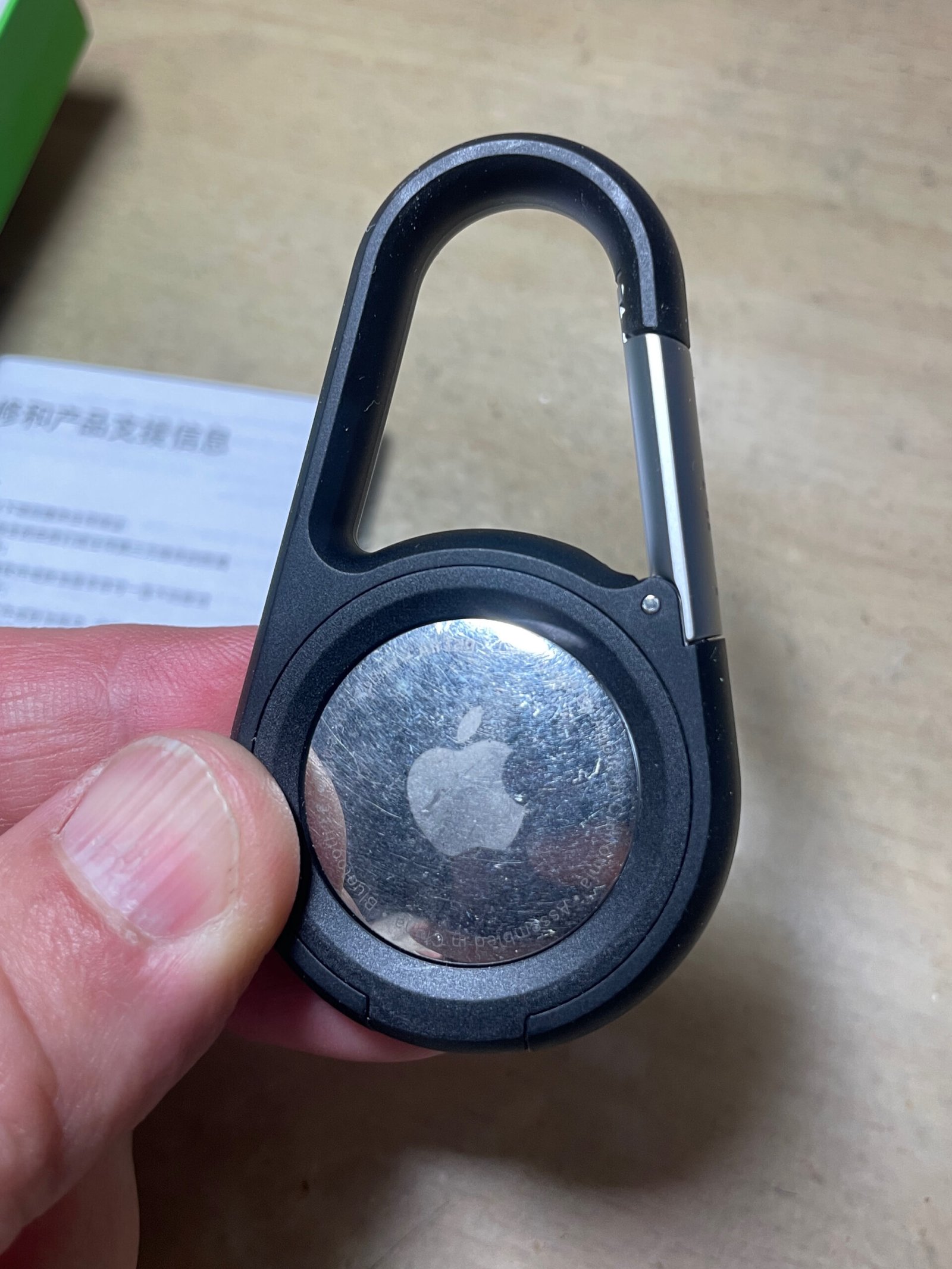 Apple AirTag in a Belkin Secure Holder with carabiner, ready to clip to luggage