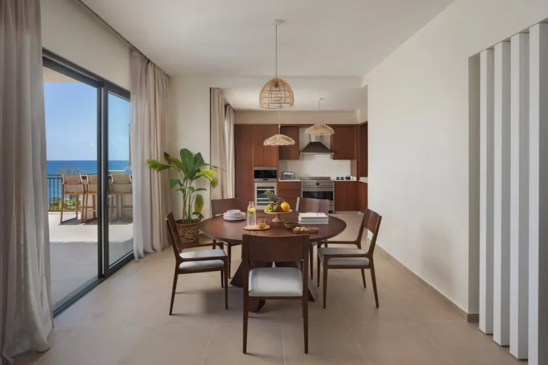 Villa dining area and open kitchen at Six Senses La Sagesse