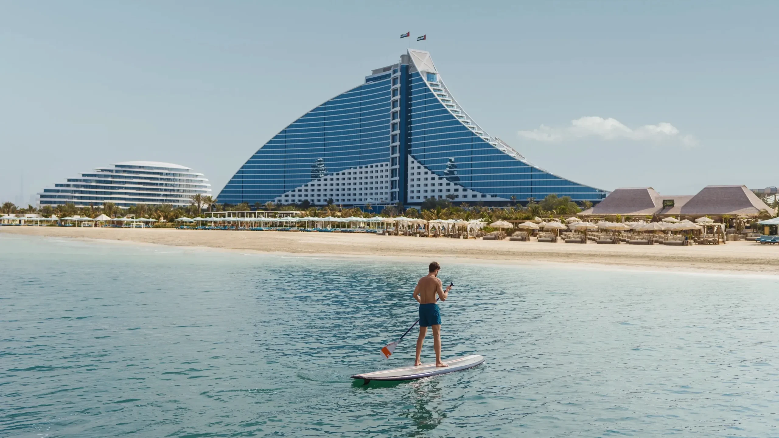 Jumeirah Beach Hotel Dubai wave-shaped exterior at dusk overlooking the Arabian Gulf