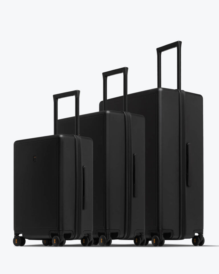 The three LEVEL8 Luminous Textured suitcases (20-inch, 24-inch, 28-inch) in black, telescopic handles aligned in a row