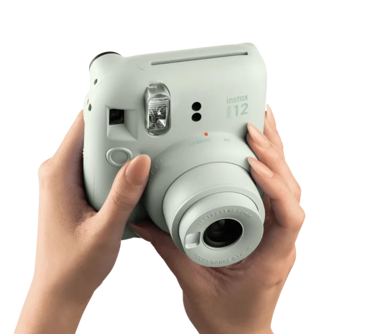 Fujifilm Instax Mini 12 feature image showing the twist-to-shoot lens operation