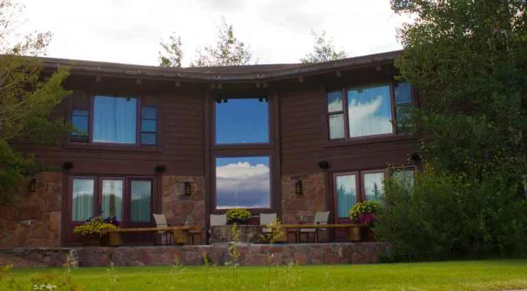 Exterior view of Midnight Trail Lodge at C Lazy U Ranch, a large private multi-bedroom log lodge