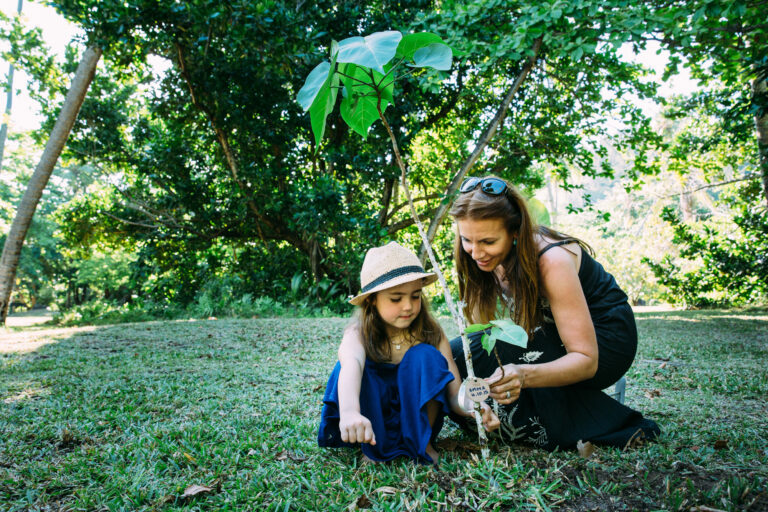 North Island, Seychelles — Conservation mom and daughter planting indigineous tree