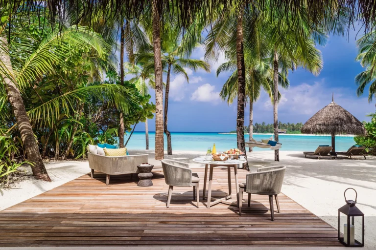 Beach Villa Queen bedroom interior at One&Only Reethi Rah with natural materials and garden view