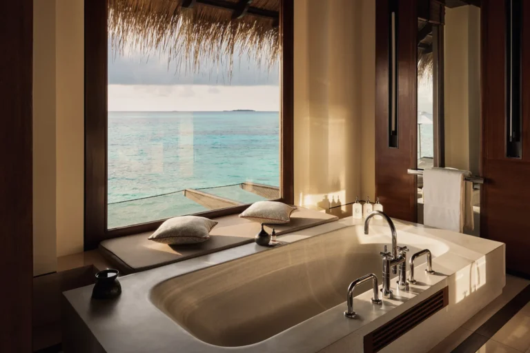 Water Villa Queen interior at One&Only Reethi Rah with floor-to-ceiling ocean views