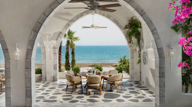Rooftop dining table at sunset overlooking the sea at Regnum The Crown