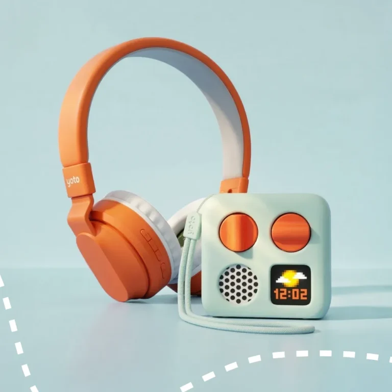 Yoto Mini in a pale green Adventure Jacket beside orange Yoto wireless headphones