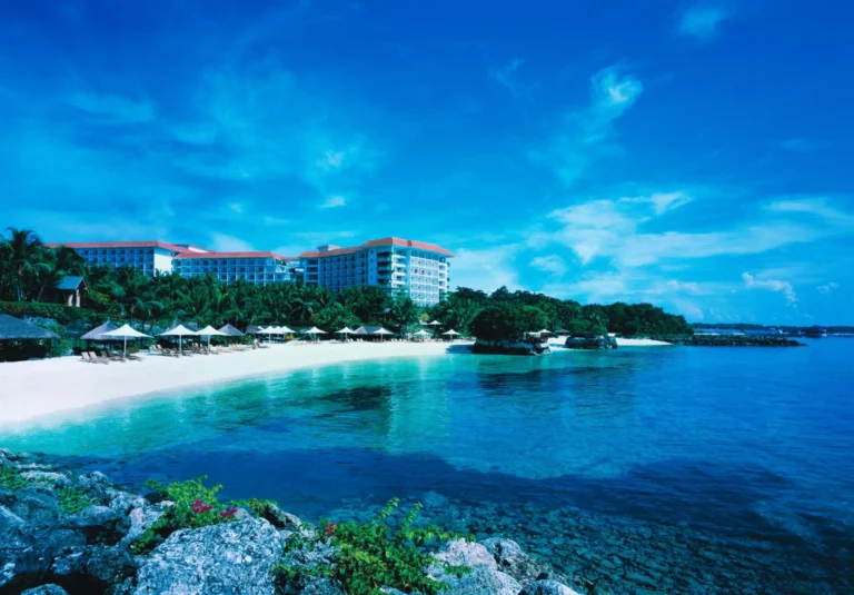 Sun loungers set in the shallow turquoise water at Shangri-La Mactan, Cebu's private beach