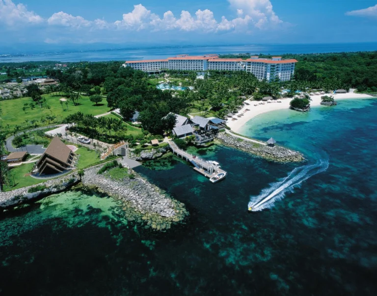 Aerial view of the full Shangri-La Mactan, Cebu property, pools, beach and Treasure Island