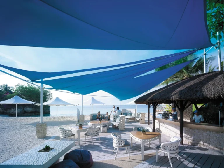 The beachfront bar and lounge under blue sail-cloth canopies at Shangri-La Mactan, Cebu